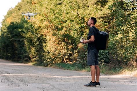 premium photo man flying  drone  road young man navigating  flying drone