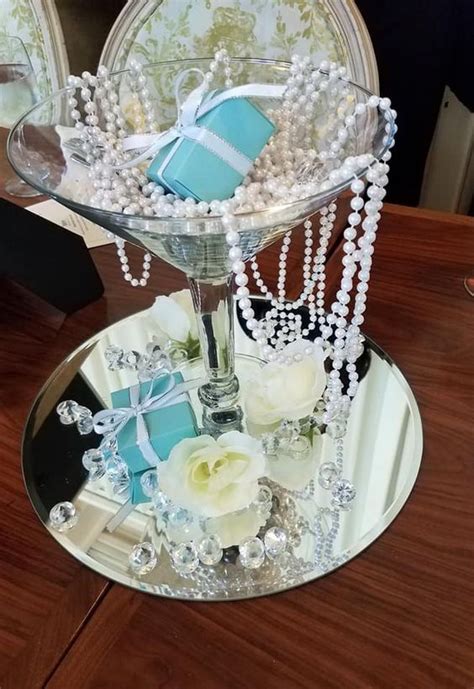 A Themed Centerpiece Of A Mirror A Large Glass Pearls Roses