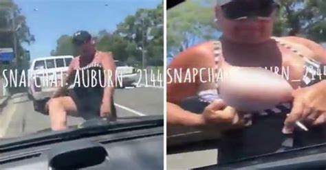 bizarre moment woman flashes boob in road rage clash leaving motorist