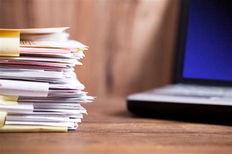 large stack  files paperwork desk office computer stock photo