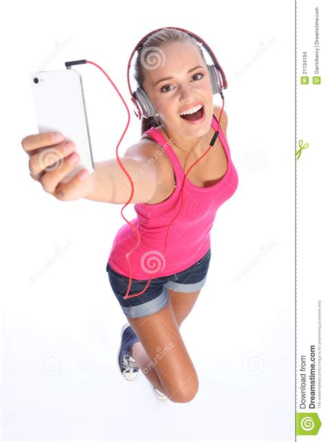 happy sexy teenage girl has music fun with phone stock