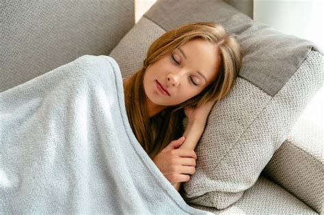 Free Photo Young Woman Lying On Sofa At Home Rest And Sleeping