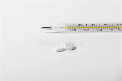 bunch of red pills and syringe with needle stock image