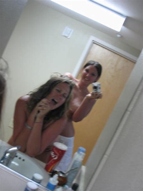 brunette teen posing topless with friend in the bathroom mirror nude amateur girls