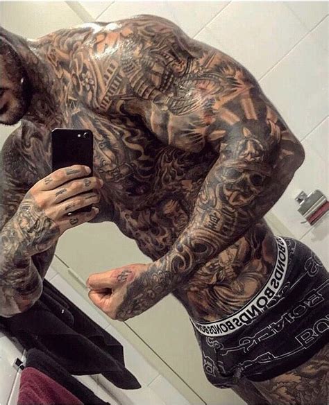 tattooed gym junkie poses with gold ak 47s and flashes his