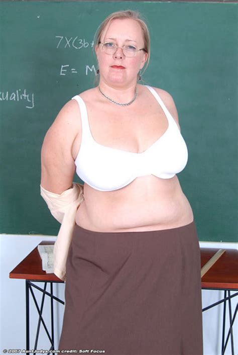 glassed plump mature teacher stripping in the classroom
