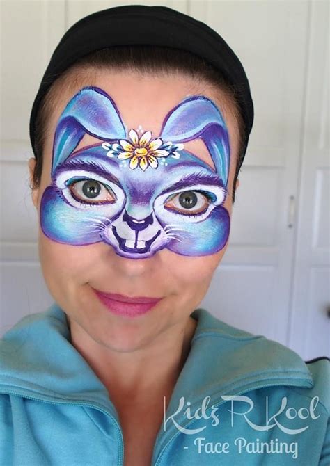 woman   face painted   cat  flowers   center