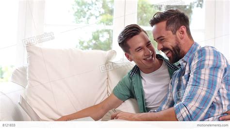 Gay Couple Relaxing On The Couch Using Laptop Stock Video Footage 8121833