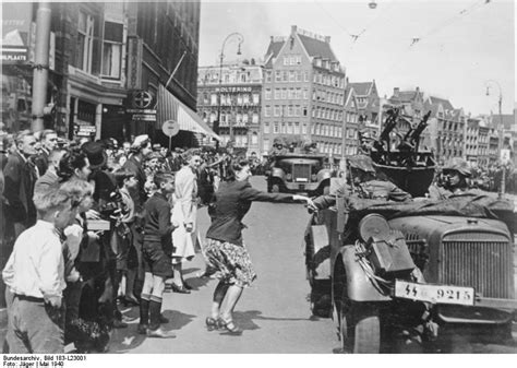 photo  dutch woman welcoming german ss troops arriving  amsterdam  netherlands