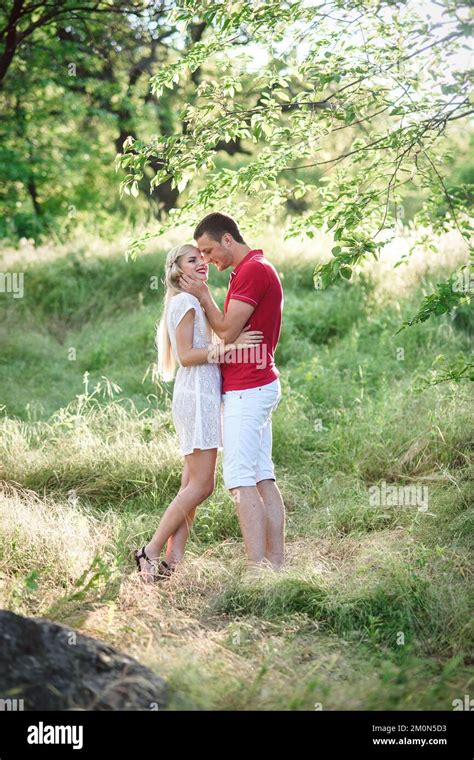 Couple In Love A Blonde Girl And A Guy In A Red T Shirt At A Picnic In
