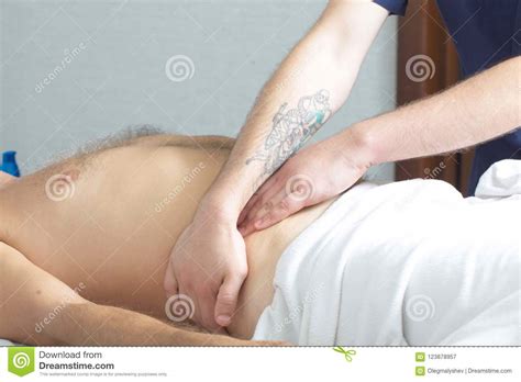 massage therapist makes a man a massage stock image