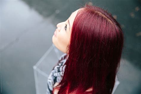 asian woman with striking red hair by stocksy contributor curtis kim