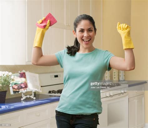 Mixed Race Woman Wearing Rubber Gloves And Holding Sponge Photo Getty