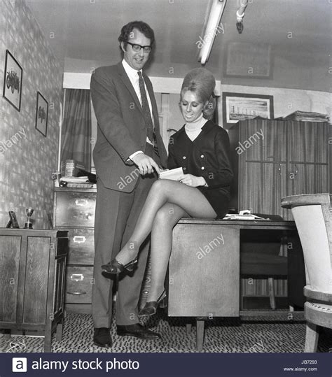 1970s historical a secretary wearing a mini skirt sits