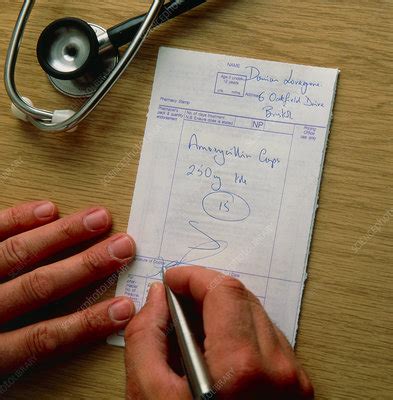 doctor signing  prescription  amoxycillin stock image