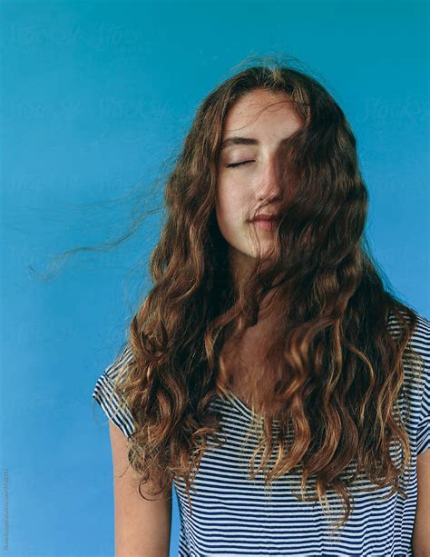 Portrait Of Teenage Girl With Eyes Closed And Facing Breeze Long