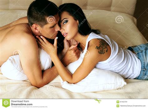 Beautiful Impassioned Couple Relaxing In Bed At The Hotel