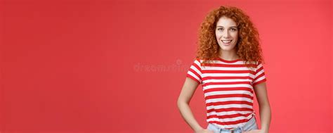 sassy confident cheeky good looking redhead curly haired woman hold