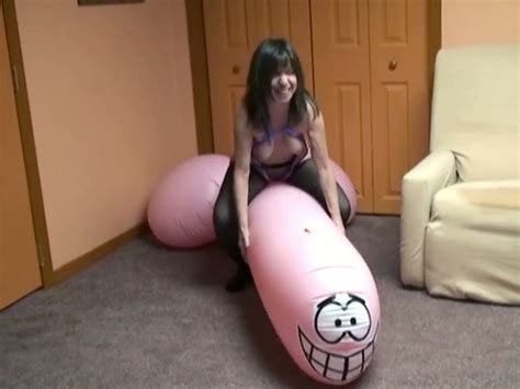 brunette vixen masturbates lying on giant inflatable dildo