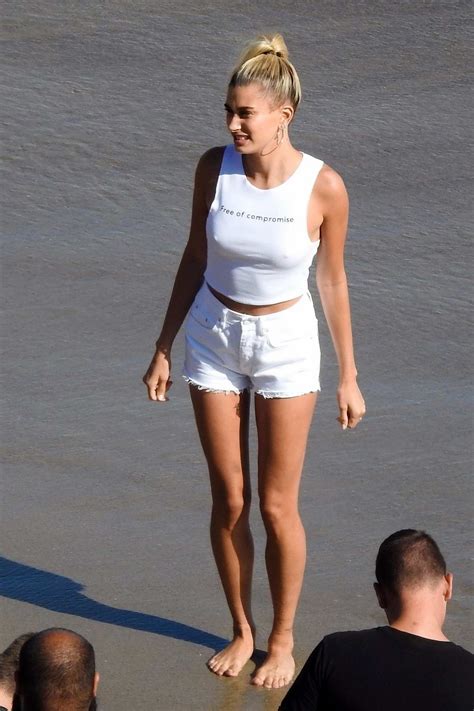 hailey baldwin poses in multiple outfit during a beach photoshoot for