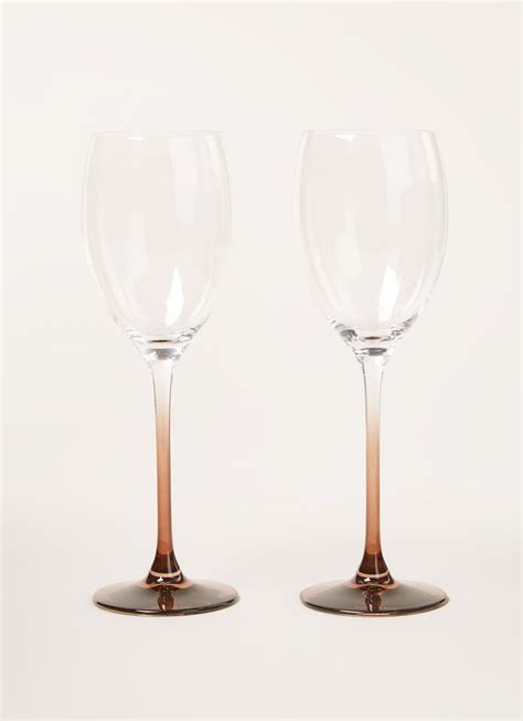 wine glasses sitting side  side  top       gold rim