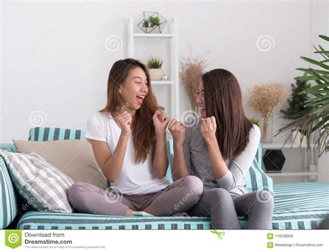 Asia Lesbian Lgbt Couple Holding Remote Watching Tv Show And Che Stock