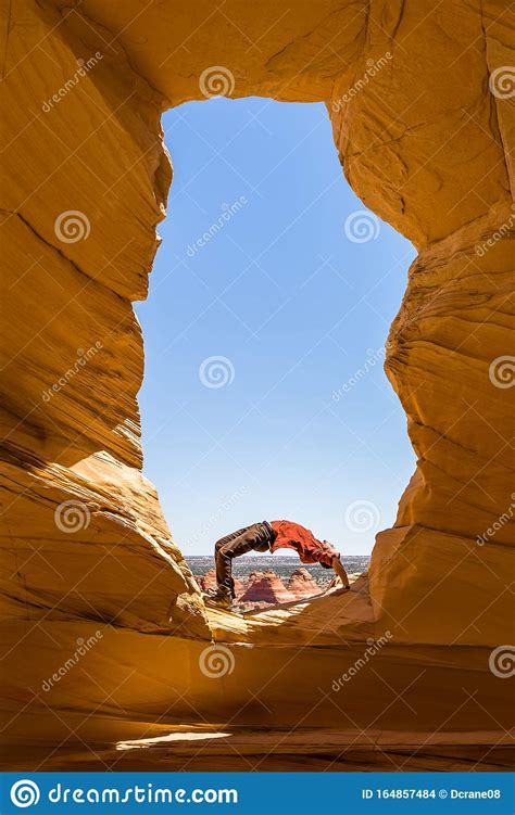 yoga   wilderness  bend  arch   window overlooking  arizona desert