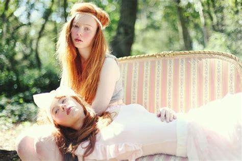 gorgeous redhead twins on a lounge girl couple redhead beauty photo