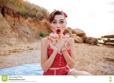 Surprised Pin Up Girl Showing Two Cream Cakes Sitting