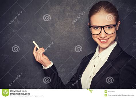 business woman teacher with glasses and a suit with chalk