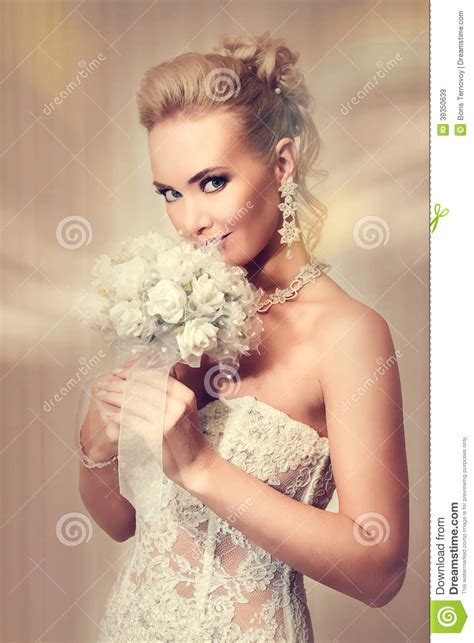 beautiful bride in elegant white lace wedding dress stock