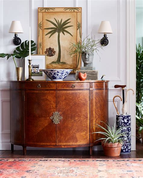 love this mix of antique accents and tropical pieces for a seriously summer ready entry