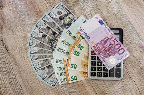 dollars euro   calculator  wooden background stock photo image  banknote financial