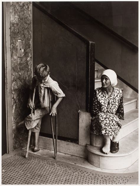 crippled boy   shoed woman wait  elevator international center  photography