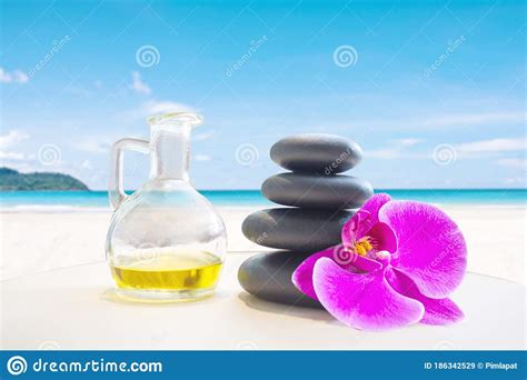 hot fragrance oil aroma therapy massage with stone over blurred