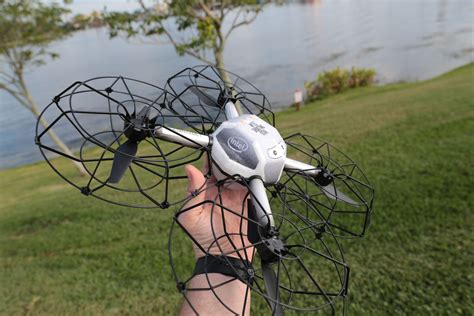 person holding   remote controlled flying device  front   body  water