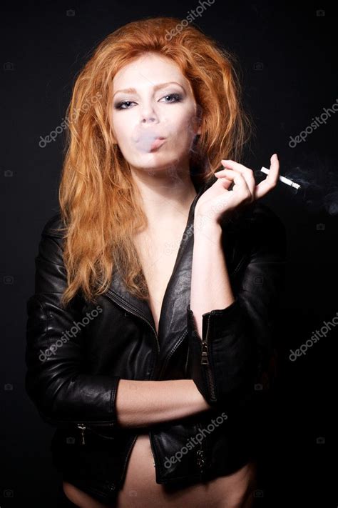 Portrait Of Beautiful Redhead Woman With A Cigarette