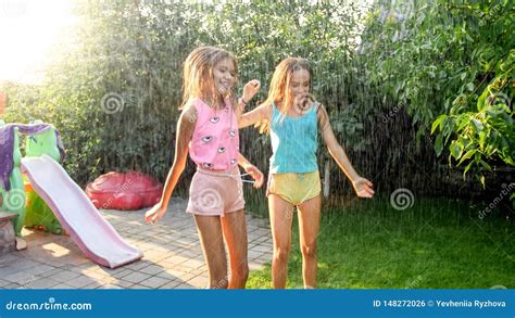image of two happy laughing teenage girls jumping and dancing under