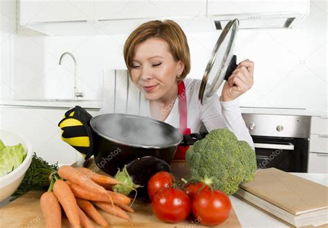 Home Cook Woman In Red Apron At Domestic Kitchen Holding