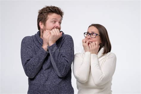 Scared Man And Woman Couple Looking Afraid On Each Other Stock Image