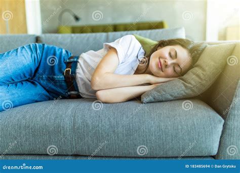 Young Attractive Girl Sleeping On The Couch In The Living Room Stock