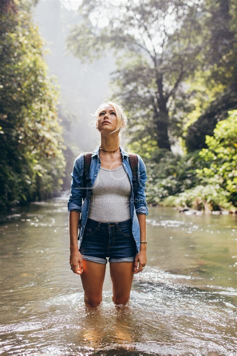attractive young hiker standing  wilderness stream jacob lund photography store premium