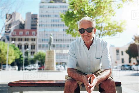 Portrait Of Handsome Senior Man Sitting Outdoors Mature Male Tourist