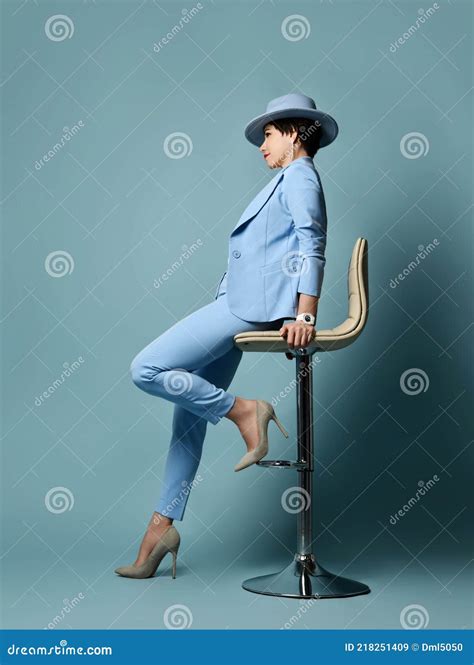 Short Haired Brunette Woman In Blue Business Suit Hat High Heeled