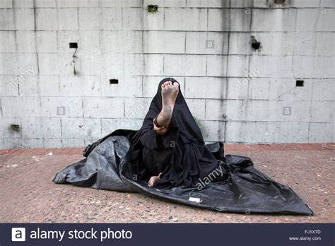 A Muslim Woman Wearing Traditional Niqab Shows Her Foot As