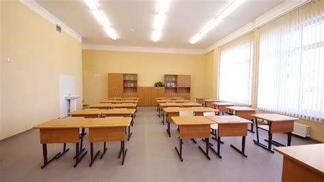 empty classroom with wooden desks white and green chalk boards in school stock footage video
