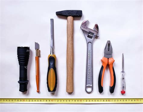 assorted color handheld tools white background work repair hammer screwdriver