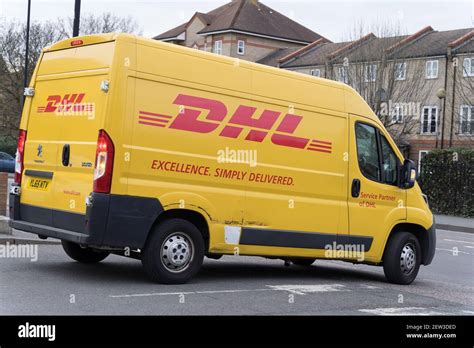 dhl yellow van     drop  parcels  customer stock photo