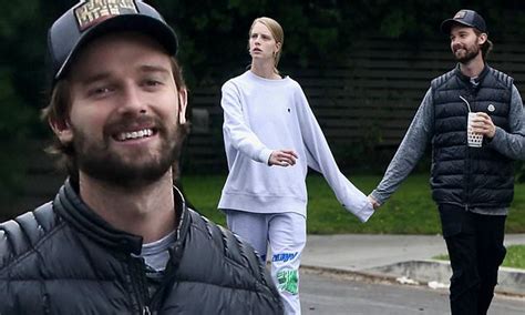 patrick schwarzenegger is all smiles as he holds hands with abby