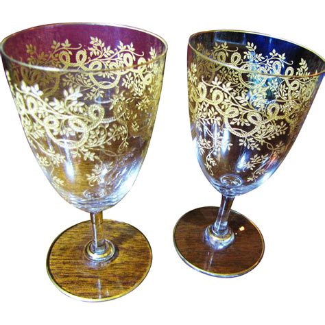 beautiful pair of heavily decorated gilt wine glasses from